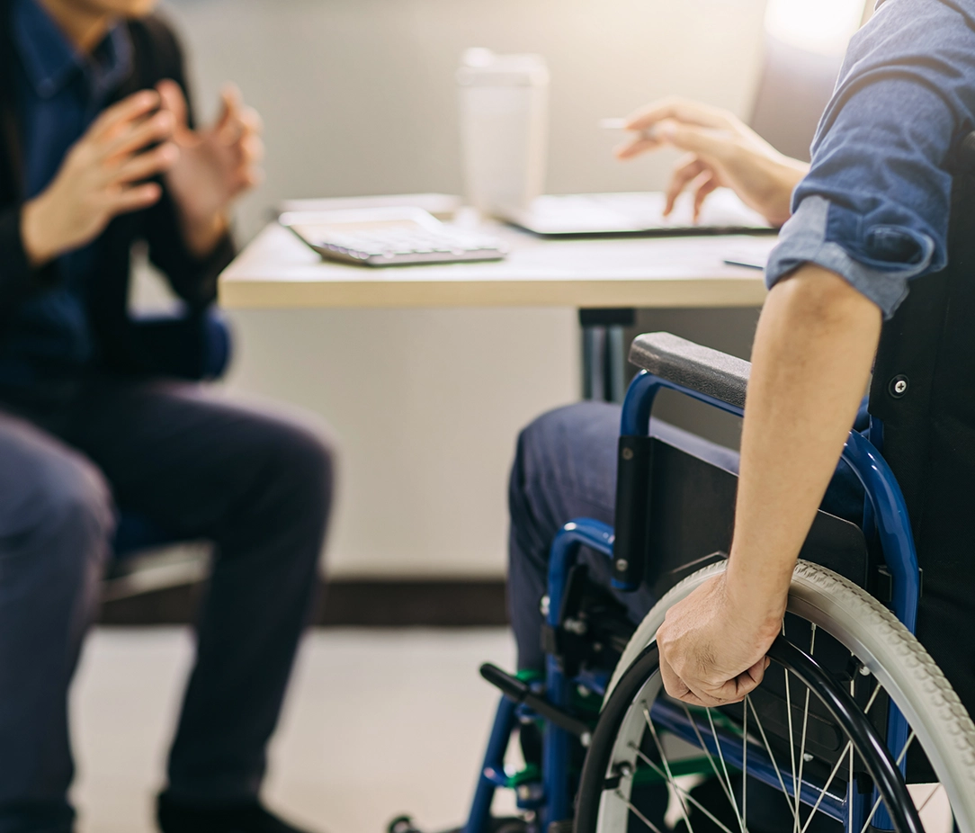 Man in wheelchair talking to an attornet